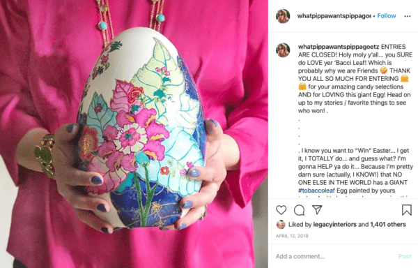 Frau hält ein Ei mit Blumenfarbe für Oster-Instagram-Wettbewerbe